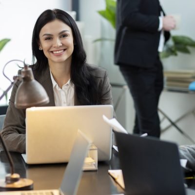 HR professional conducting a workplace discussion using a laptop in a modern office environment