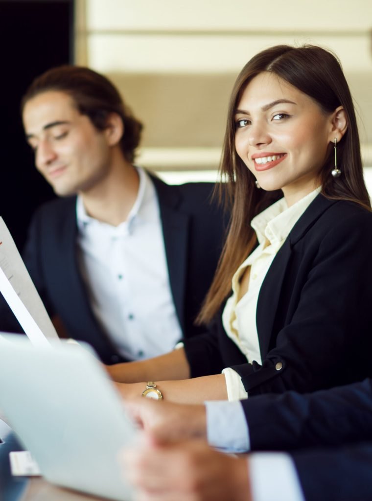 HR professionals reviewing documents during a team meeting in a corporate office