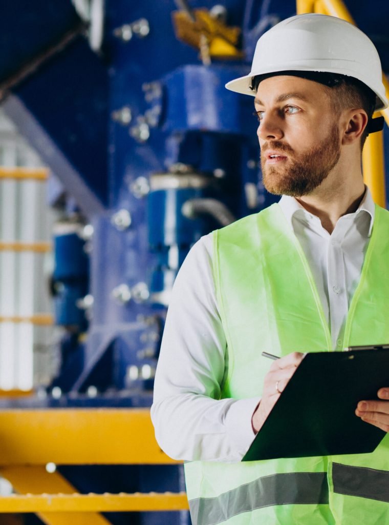 Workman in a factory writing notes Rig Safety Officer GCC Drilling Academy